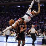 
              Washington Wizards' Daniel Gafford (21) fouls New York Knicks' Alec Burks (18) during the third quarter of an NBA basketball game Friday, March 18, 2022, in New York. (AP Photo/Jason DeCrow)
            