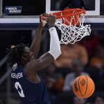 
              Longwood forward Leslie Nkereuwem dunks the ball during the second half of a college basketball game against Tennessee in the first round of the NCAA tournament in Indianapolis, Thursday, March 17, 2022. (AP Photo/Michael Conroy)
            