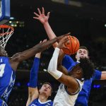 
              Creighton's Arthur Kaluma, left, blocks a shot by Villanova's Jordan Longino, front right, as Creighton's Ryan Kalkbrenner, right, defends during the first half of an NCAA college basketball game in the final of the Big East conference tournament Saturday, March 12, 2022, in New York. (AP Photo/Frank Franklin II)
            