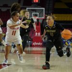 
              Delaware guard Paris McBride (4) drives against Maryland guard Katie Benzan (11) during the first half of a college basketball game in the first round of the NCAA tournament, Friday, March 18, 2022, in College Park, Md. (AP Photo/Julio Cortez)
            