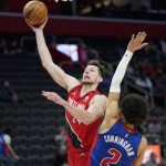 
              Portland Trail Blazers forward Drew Eubanks (24) drives on Detroit Pistons guard Cade Cunningham (2) in the second half of an NBA basketball game in Detroit, Monday, March 21, 2022. (AP Photo/Paul Sancya)
            