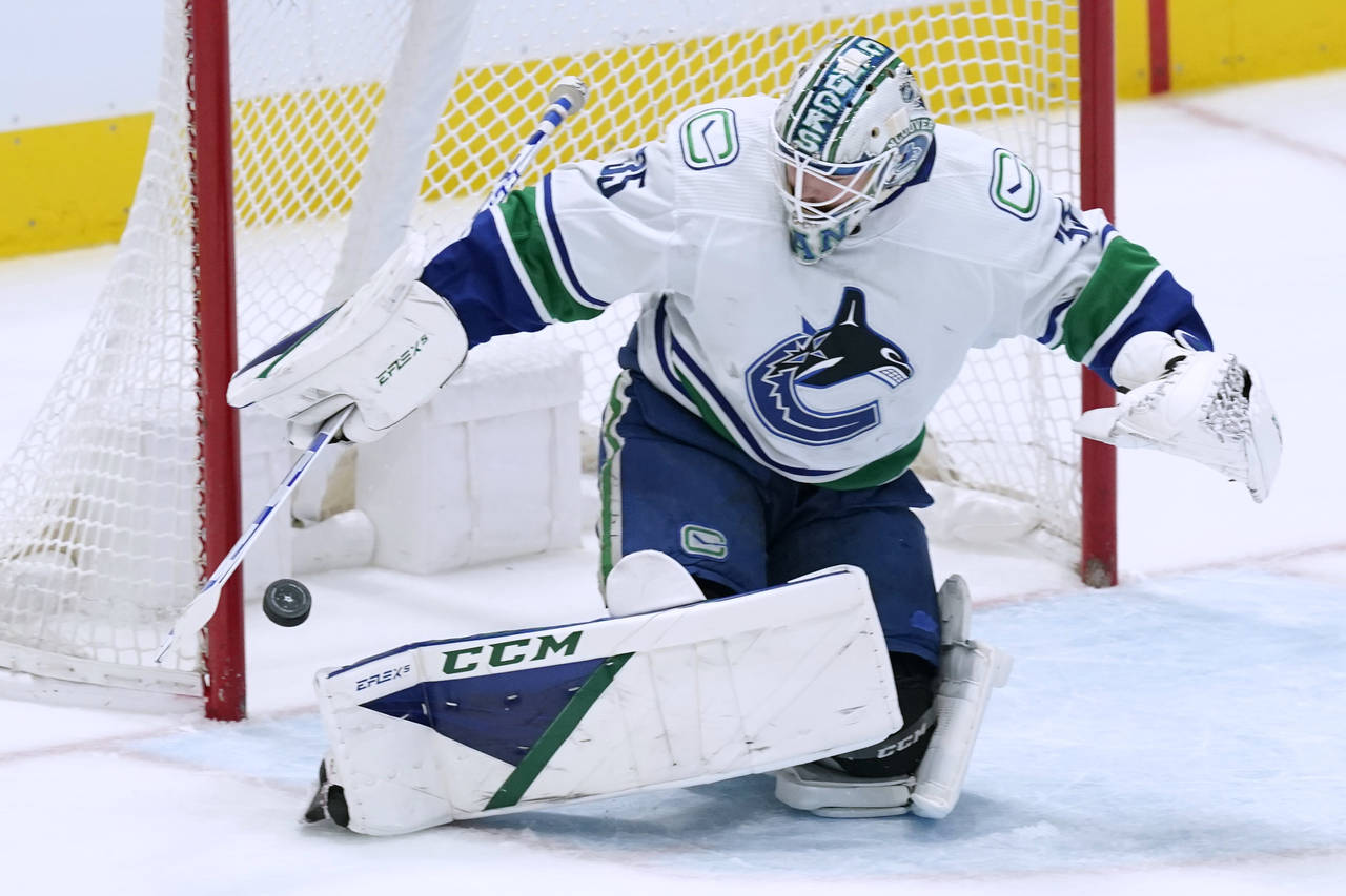 Vancouver Canucks goaltender Thatcher Demko turns away a shot during the first period of the team's...