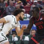 
              Colorado State guard David Roddy, left, drives as San Diego State forward Aguek Arop defends during the first half of an NCAA college basketball game in the semifinals of Mountain West Conference men's tournament Friday, March 11, 2022, in Las Vegas. (AP Photo/Rick Bowmer)
            