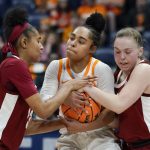 
              Tennessee's Brooklynn Miles, center, tries to hang onto the ball as Alabama's Brittany Davis, left, and Hannah Barber, right, try to take it away in the first half of an NCAA college basketball game at the women's Southeastern Conference tournament Friday, March 4, 2022, in Nashville, Tenn. (AP Photo/Mark Humphrey)
            
