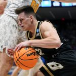 
              Bryant guard Peter Kiss, center right, drives past Wright State's Grant Basile (0) during the first half of a First Four game in the NCAA men's college basketball tournament, Wednesday, March 16, 2022, in Dayton, Ohio. (AP Photo/Jeff Dean)
            