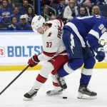 
              Carolina Hurricanes right wing Andrei Svechnikov (37) gets aroud Tampa Bay Lightning defenseman Mikhail Sergachev (98) during the first period of an NHL hockey game Tuesday, March 29, 2022, in Tampa, Fla. (AP Photo/Chris O'Meara)
            