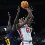 
              Utah's Peyton McFarland (42) shoots voer California's Fatou Samb (33) during the first half of an NCAA college basketball game in the first round of the Pac-12 women's tournament Wednesday, March 2, 2022, in Las Vegas. (AP Photo/John Locher)
            