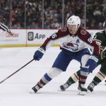 
              Colorado Avalanche right wing Mikko Rantanen (96) handles the puck against Minnesota Wild right wing Brandon Duhaime (21) during the second period of an NHL hockey game Sunday, March 27, 2022, in St. Paul, Minn. (AP Photo/Stacy Bengs)
            
