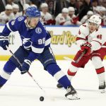 
              Tampa Bay Lightning defenseman Mikhail Sergachev (98) congrols the puck in front of Carolina Hurricanes left wing Teuvo Teravainen (86) during the first period of an NHL hockey game Tuesday, March 29, 2022, in Tampa, Fla. (AP Photo/Chris O'Meara)
            