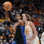 
              Tennessee's Tess Darby (21) reaches around Kentucky's Robyn Benton (1) in the first half of an NCAA college basketball semifinal round game at the women's Southeastern Conference tournament Saturday, March 5, 2022, in Nashville, Tenn. (AP Photo/Mark Humphrey)
            
