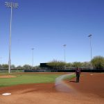 
              An Arizona Diamondbacks groundskeeper prepares a baseball field for the first day of spring training, Friday, March 11, 2022, in Scottsdale, Ariz. (AP Photo/Matt York)
            
