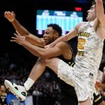 
              Bryant forward Hall Elisias, center left, and Wright State's Andrew Welage (22) fight for a loose ball during the first half of a First Four game in the NCAA men's college basketball tournament, Wednesday, March 16, 2022, in Dayton, Ohio. (AP Photo/Jeff Dean)
            