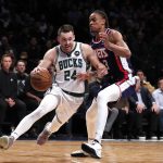 
              Milwaukee Bucks guard Pat Connaughton (24) drives to the basket against Brooklyn Nets forward Nic Claxton (33) during the first half of an NBA basketball game Thursday, March 31, 2022, in New York. (AP Photo/Noah K. Murray)
            