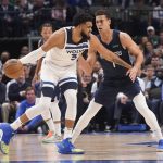 
              Minnesota Timberwolves center Karl-Anthony Towns, left, dribbles against Dallas Mavericks center Dwight Powell, right, during the first quarter of an NBA basketball game in Dallas, Monday, March 21, 2022. (AP Photo/LM Otero)
            