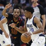 
              Dallas Mavericks guard Brandon Knight (20) drives against Cleveland Cavaliers guard Darius Garland (10) during the first half of an NBA basketball game Wednesday, March 30, 2022, in Cleveland. (AP Photo/Ron Schwane)
            