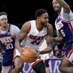 
              Miami Heat forward Haywood Highsmith (24) drives to the net against Brooklyn Nets forward James Johnson (16) during the first half of an NBA basketball game Thursday, March 3, 2022, in New York. (AP Photo/John Minchillo)
            