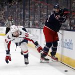 
              Washington Capitals forward forward Tom Wilson, left, reaches for the puck behind Columbus Blue Jackets forward Yegor Chinakhov during the second period of an NHL hockey game in Columbus, Ohio, Thursday, March 17, 2022. (AP Photo/Paul Vernon)
            