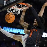 
              Miami guard Jordan Miller dunks past Auburn forward Walker Kessler during the first half of a college basketball game in the second round of the NCAA tournament on Sunday, March 20, 2022, in Greenville, S.C. (AP Photo/Chris Carlson)
            