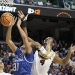 
              South Carolina forward Aliyah Boston (4) blocks Creighton forward Emma Ronsiek (31) during the first half of a college basketball game in the Elite 8 round of the NCAA tournament in Greensboro, N.C., Sunday, March 27, 2022. (AP Photo/Gerry Broome)
            