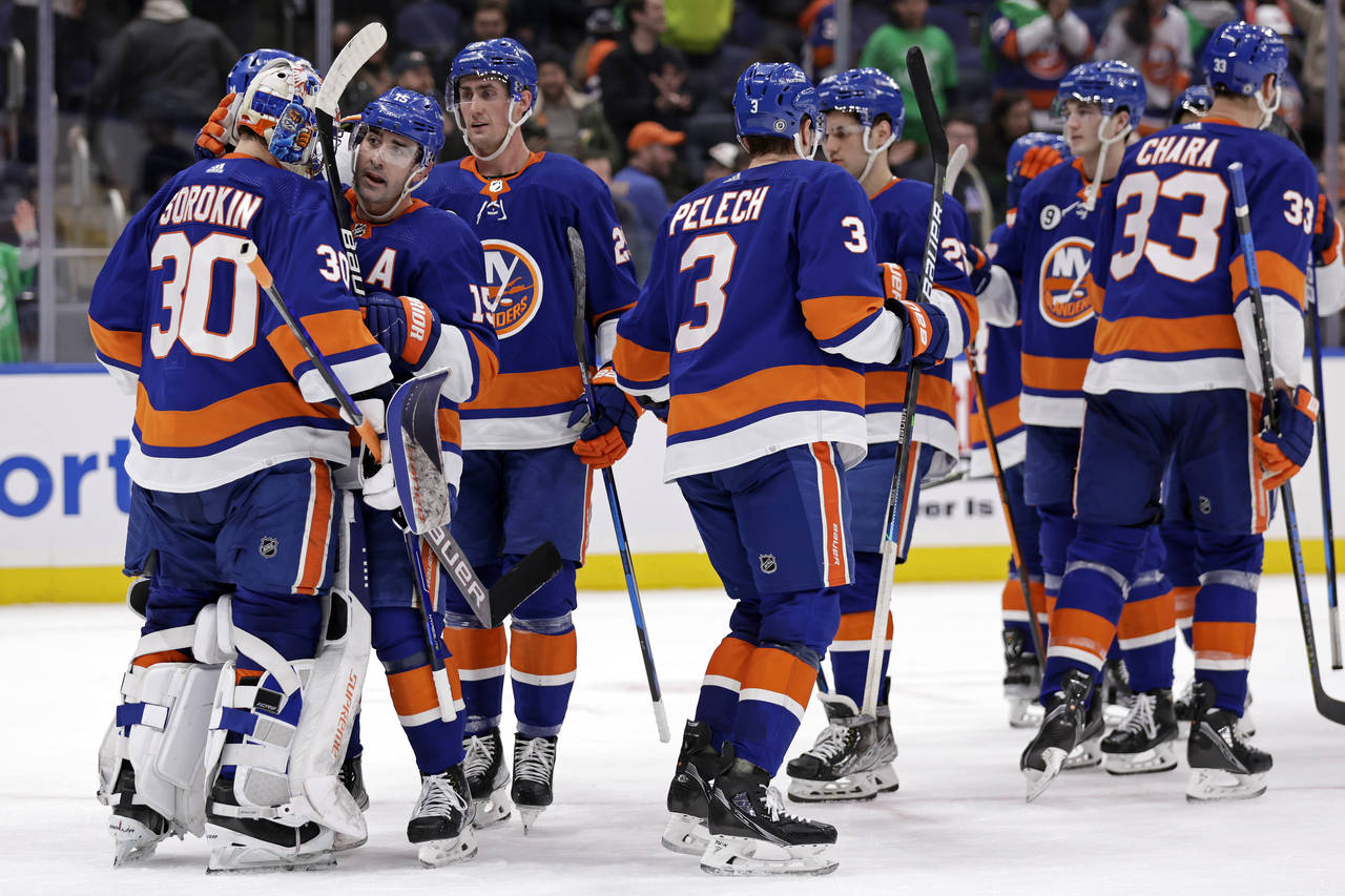 New York Islanders goaltender Ilya Sorokin (30) is congratulated by teammates after defeating the A...