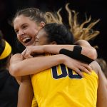 
              Michigan's Naz Hillmon (00) and Emily Kiser, left, celebrate a 52-49 victory over South Dakota following a college basketball game in the Sweet 16 round of the NCAA women's tournament Saturday, March 26, 2022, in Wichita, Kan. (AP Photo/Jeff Roberson)
            