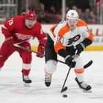 
              Philadelphia Flyers right wing Owen Tippett (74) skates with the puck as Detroit Red Wings left wing Adam Erne (73) pursues in the first period of an NHL hockey game Tuesday, March 22, 2022, in Detroit. (AP Photo/Paul Sancya)
            