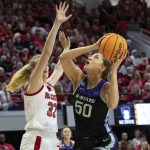 
              Kansas State's Ayoka Lee (50) attempts to shoot as North Carolina State's Elissa Cunane (33) defends during the first half of a college basketball game in the second round of the NCAA tournament in Raleigh, N.C., Monday, March 21, 2022. (AP Photo/Ben McKeown)
            
