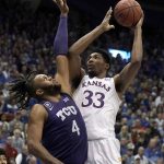 
              Kansas forward David McCormack (33) shoots over TCU center Eddie Lampkin (4) during the first half of an NCAA college basketball game Thursday, March 3, 2022, in Lawrence, Kan. (AP Photo/Charlie Riedel)
            