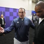 
              Duke coach Mike Krzyzewski, left, and North Carolina coach Hubert Davis make their way to an interview at the men's Final Four NCAA college basketball tournament Thursday, March 31, 2022, in New Orleans. Duke will play North Carolina on Saturday. (AP Photo/David J. Phillip)
            