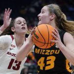 
              Missouri's Hayley Frank (43) drives against Arkansas' Sasha Goforth (13) in the first half of an NCAA college basketball game at the women's Southeastern Conference tournament Thursday, March 3, 2022, in Nashville, Tenn. (AP Photo/Mark Humphrey)
            
