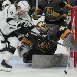 
              Vegas Golden Knights goaltender Logan Thompson (36) knocks the puck away from Los Angeles Kings center Adrian Kempe (9) during the third period of an NHL hockey game Saturday, March 19, 2022, in Las Vegas. (AP Photo/John Locher)
            