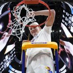 
              Kansas' Mitch Lightfoot cuts down the net after a college basketball game in the Elite 8 round of the NCAA tournament Sunday, March 27, 2022, in Chicago. Kansas won 76-50 to advance to the Final Four. (AP Photo/Nam Y. Huh)
            