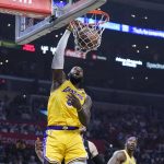 
              Los Angeles Lakers forward LeBron James dunks against the Los Angeles Clippers during the first half of an NBA basketball game Thursday, March 3, 2022, in Los Angeles. (AP Photo/Marcio Jose Sanchez)
            