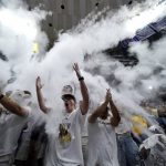 
              LSU fans in the student section throw talcum powder into the air before the start of an NCAA college basketball game against Alabama in Baton Rouge, La., Saturday, March 5, 2022. (AP Photo/Gerald Herbert)
            