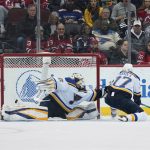 
              New Jersey Devils' Dawson Mercer, not pictured, scores past St. Louis Blues goaltender Ville Husso, left, and Niko Mikkola during the second period of the NHL hockey game in Newark, N.J., Sunday, March 6, 2022. (AP Photo/Seth Wenig)
            