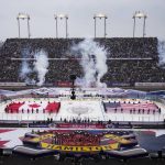 
              The national anthems are played before the Toronto Maple Leafs play against the Buffalo Sabres at an NHL Heritage Classic hockey game in Hamilton, Ontario, Sunday, March 13, 2022. (Nathan Denette/The Canadian Press via AP)
            