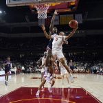 
              Southern California guard Boogie Ellis (0) drives to the basket past Arizona guard Bennedict Mathurin during the first half of an NCAA college basketball game Tuesday, March 1, 2022, in Los Angeles. (AP Photo/Marcio Jose Sanchez)
            