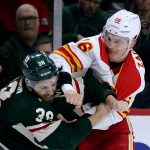 
              Calgary Flames defenseman Nikita Zadorov (16) and Minnesota Wild right wing Ryan Hartman (38) fight during the first period of an NHL hockey game Tuesday, March 1, 2022, in St. Paul, Minn. (AP Photo/Andy Clayton-King)
            