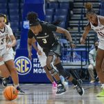 
              Vanderbilt's Jordyn Cambridge, center, chases after the ball with Texas A&M's Destiny Pitts, left, and Kayla Wells (11) in the first half of an NCAA college basketball game at the women's Southeastern Conference tournament Wednesday, March 2, 2022, in Nashville, Tenn. (AP Photo/Mark Humphrey)
            