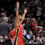 
              New Orleans Pelicans guard CJ McCollum reacts to the fans as he enters the game after a timeout in which a highlight video of him as a Portland Trail Blazer was played, during the first half of an NBA basketball game in Portland, Ore., Wednesday, March 30, 2022. It was the first game back in Portland for the longtime Blazer, who was traded to the Pelicans in February. (AP Photo/Steve Dykes)
            