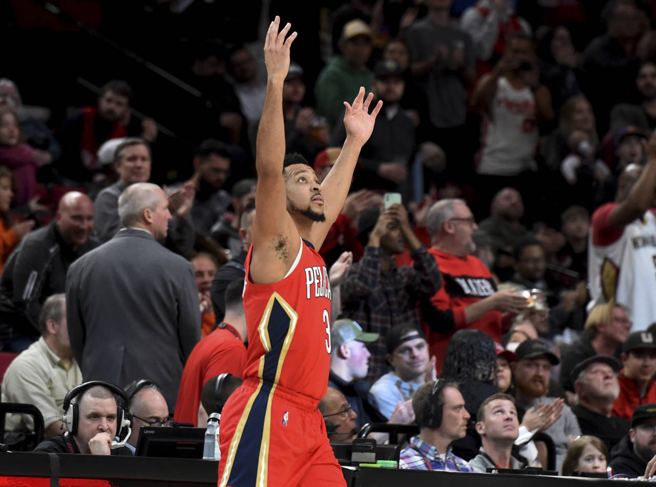 New Orleans Pelicans guard CJ McCollum reacts to the fans as he enters the game after a timeout in ...