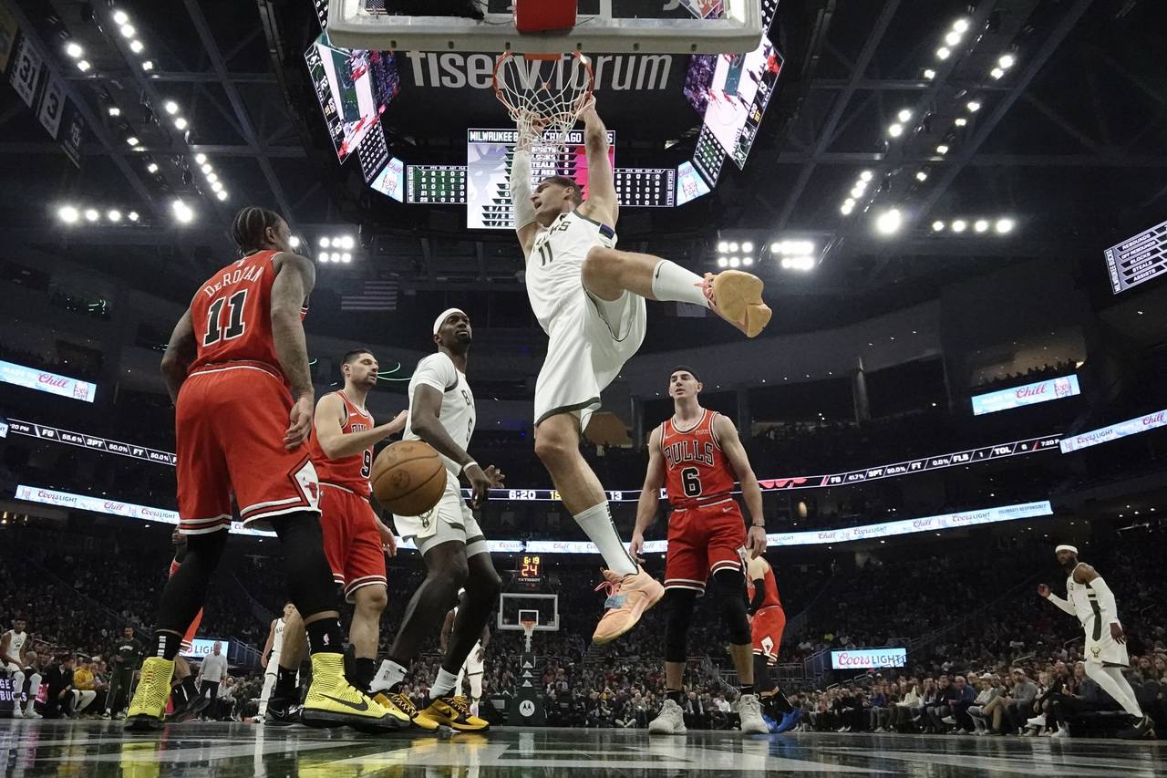 Milwaukee Bucks' Brook Lopez dunks during the firsyt half of an NBA basketball game against the Chi...