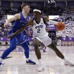 
              Kansas guard Christian Braun, left, defends as TCU forward Emanuel Miller (2) works to the basket in the second half of an NCAA college basketball game in Fort Worth, Texas, Tuesday, March 1, 2022. (AP Photo/Tony Gutierrez)
            