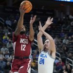 
              Washington State's Michael Flowers (12) shoots over UCLA's Jaime Jaquez Jr. (24) during the first half of an NCAA college basketball game in the quarterfinal round of the Pac-12 tournament Thursday, March 10, 2022, in Las Vegas. (AP Photo/John Locher)
            