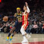 
              Indiana Pacers guard Buddy Hield (24) dribbles past Atlanta Hawks guard Trae Young, right, during the second half of an NBA basketball game Sunday, March 13, 2022, in Atlanta. (AP Photo/Hakim Wright Sr.)
            