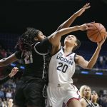 
              Connecticut's Olivia Nelson-Ododa (20) shoots as Georgetown's Ariel Jenkins (21) defends in the first half of an NCAA college basketball game in the quarterfinals of the Big East Conference tournament at Mohegan Sun Arena, Saturday, March 5, 2022, in Uncasville, Conn. (AP Photo/Jessica Hill)
            