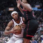 
              Cleveland Cavaliers forward Lamar Stevens (8) drives into Toronto Raptors forward Scottie Barnes (4) during the second half of an NBA basketball game Thursday, March 24, 2022, in Toronto. (Nathan Denette/The Canadian Press via AP)
            