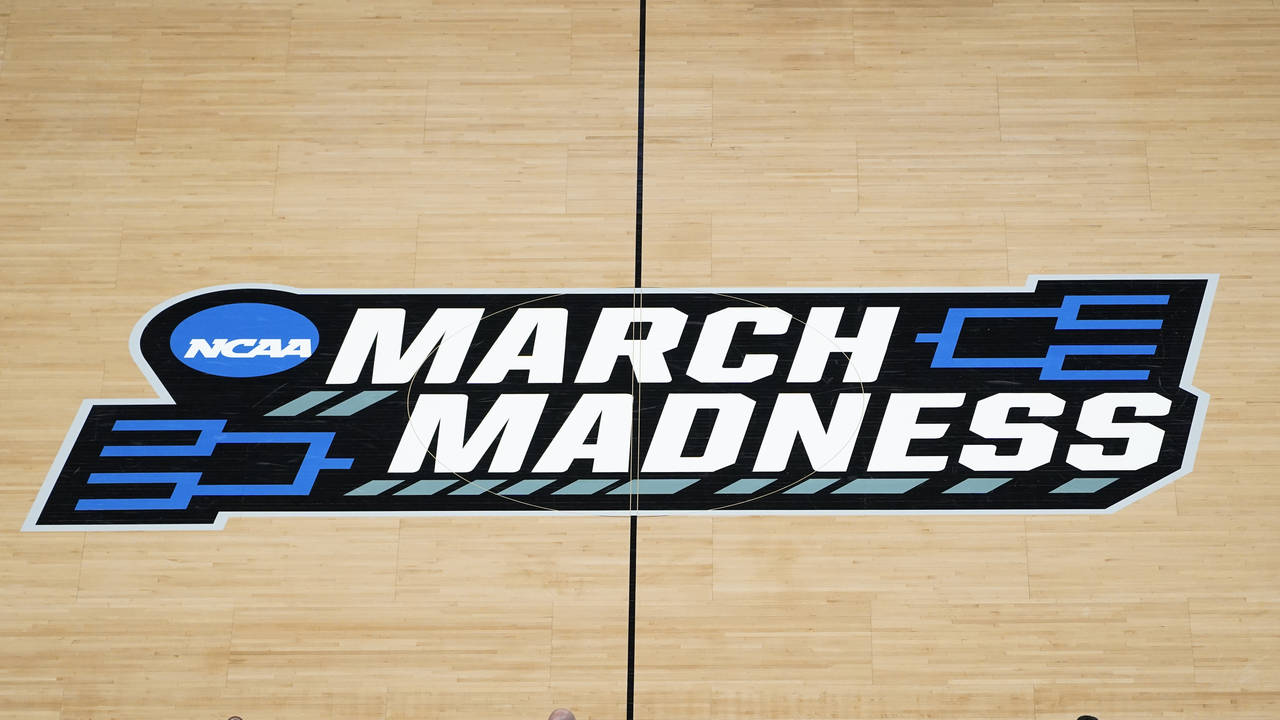 FILE -The March Madness logo is shown on the court during the first half of a men's college basketb...