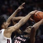 
              Louisville's Jae'Lyn Withers shoots while defended by Virginia Tech's David N'Guessan (1) during the first half of an NCAA college basketball game Tuesday, March 1, 2022, in Blacksburg, Va. (Matt Gentry/The Roanoke Times via AP)
            