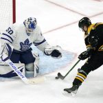 
              Toronto Maple Leafs goaltender Erik Kallgren (50) drops to the while making the save on a shot by Boston Bruins center Curtis Lazar, right, during the second period of an NHL hockey game, Tuesday, March 29, 2022, in Boston. (AP Photo/Charles Krupa)
            